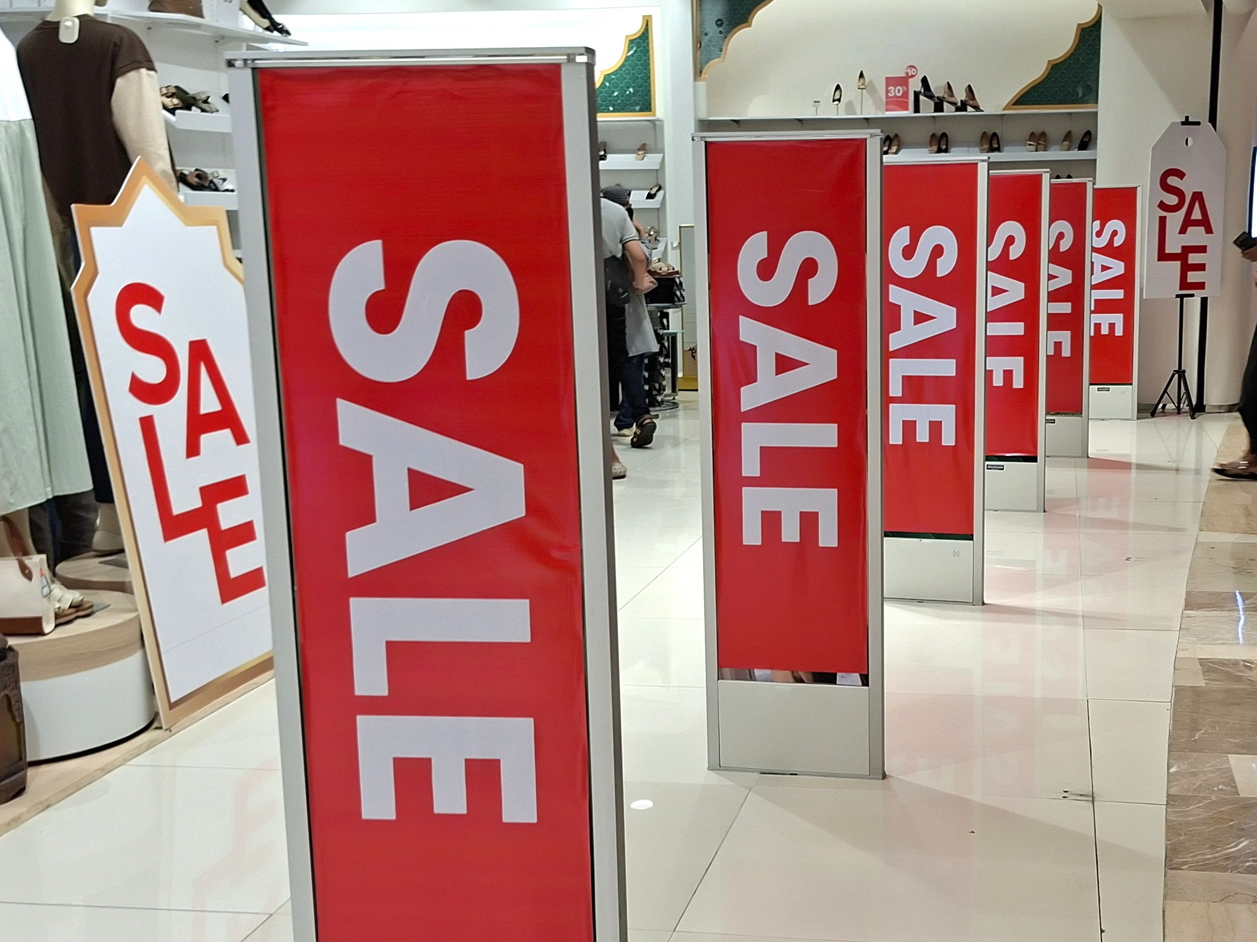 Storefront entrance with tall promotional banners and strong visual signage